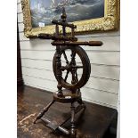 A provincial mahogany and beech spinning wheel, height 67cm