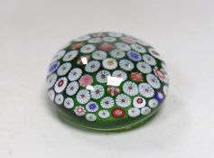 A 19th century French glass millefleur spaced cane paperweight, 8.5cms diameter