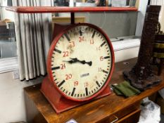An industrial style painted metal clock console table modelled as a set of scales, width 102cm,