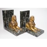 A pair of Art Deco bronze and serpentine 'sphinx' bookends, 17cms wide x 15.5cms high