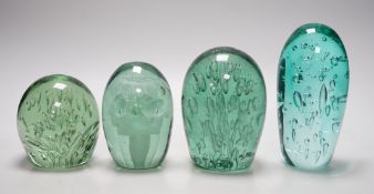 Four 19th century green glass dumps, one floral, tallest 16cms high