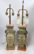 A pair of archaic Chinese bronze vases, converted into table lamps, 62cms high including light