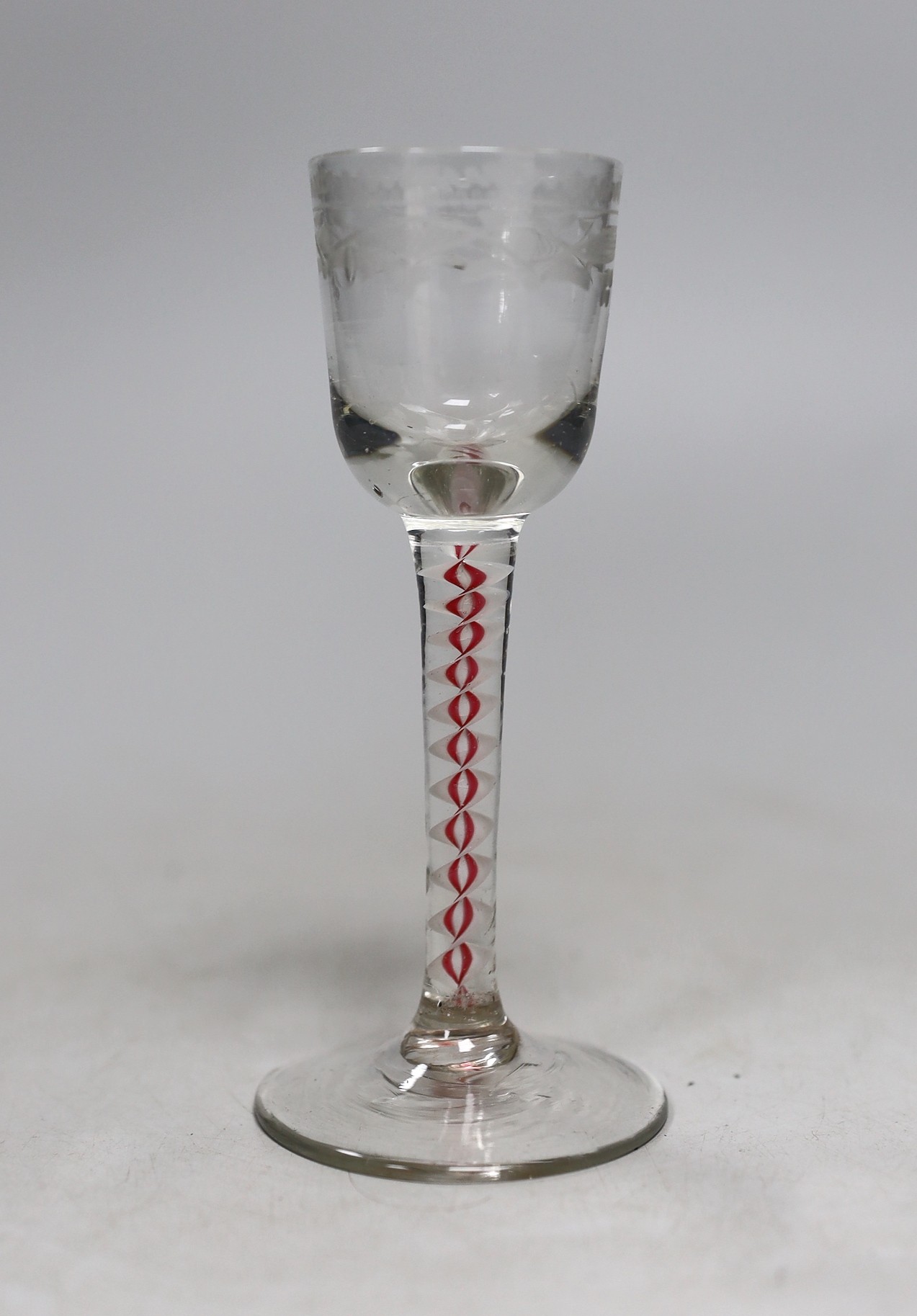 A Dutch red and white colour twist stem cordial glass, 13cms high