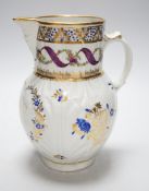 An 18th century Caughley very rare polychrome mask jug, elaboratley painted and gilded with two