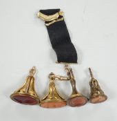 Four assorted 19th century gold plated and agate or hardstone set oval fob seals, largest 37mm,