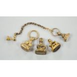 Four assorted 19th century gold plated fob seals, set with citrine, glass or carnelian, largest