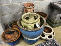 Ten assorted terracotta and glazed earthenware garden planters and three saucer bases, largest