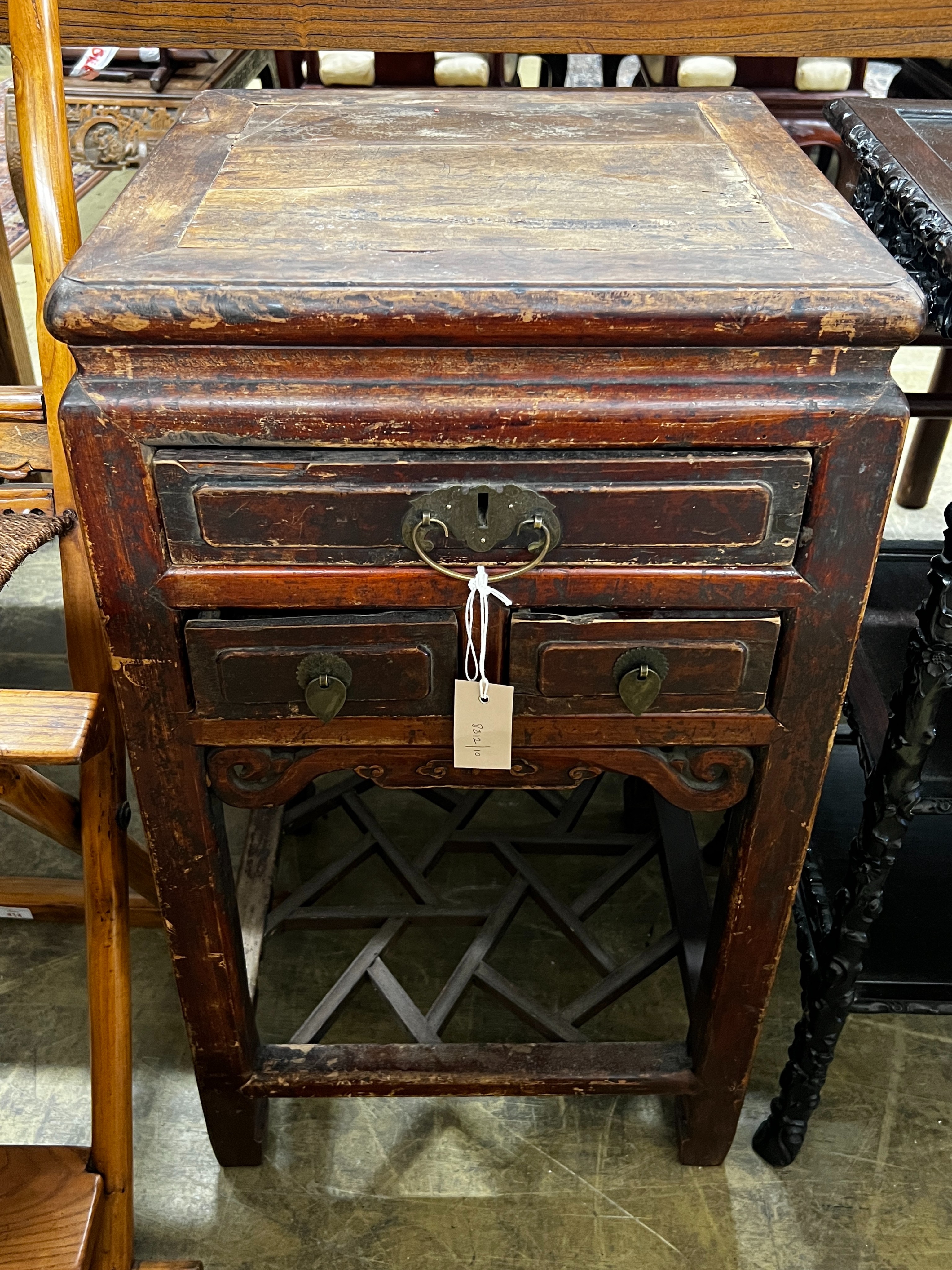 A Chinese lacquered wood three drawer side table, width 43cm, depth 44cm, height 77cm