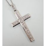 A white metal(stamped platin) and diamond set cross pendant, overall 46mm, on a white metal chain,