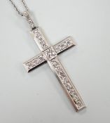 A white metal(stamped platin) and diamond set cross pendant, overall 46mm, on a white metal chain,