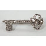 An early 20th century white metal and rose cut diamond set 'key of the door' brooch, 33mm, gross