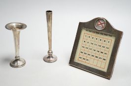 A white metal mounted desk calendar, with inset flag and two small silver mounted vases.