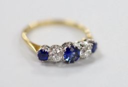 An 18ct, three stone sapphire and two stone diamond set half hoop ring, size P, gross weight 2.7