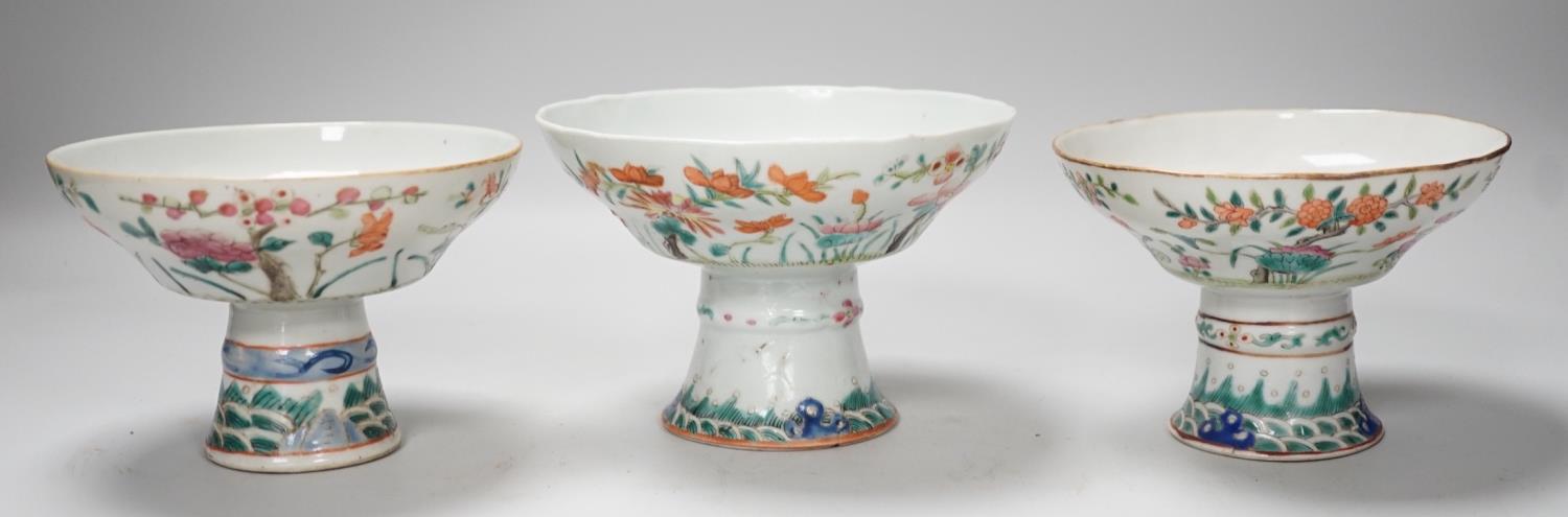 Three 19th century Chinese famille rose pedestal stem bowls, each painted with flowers and