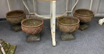 A set of four cast iron urns, diameter 24cm, height 23cm