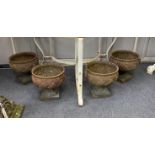 A set of four cast iron urns, diameter 24cm, height 23cm