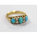 A late Victorian 18ct gold, three stone turquoise and four stone diamond set half hoop ring, size L,