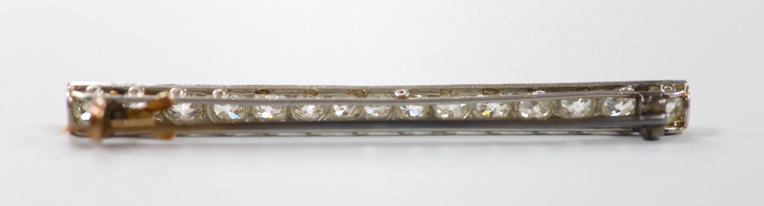 A 1920's white metal and millegrain set fifteen stone diamond bar brooch, 55mm, gross weight 4.6 - Image 2 of 2