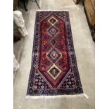 A Caucasian style red ground runner 200cm x 76cm