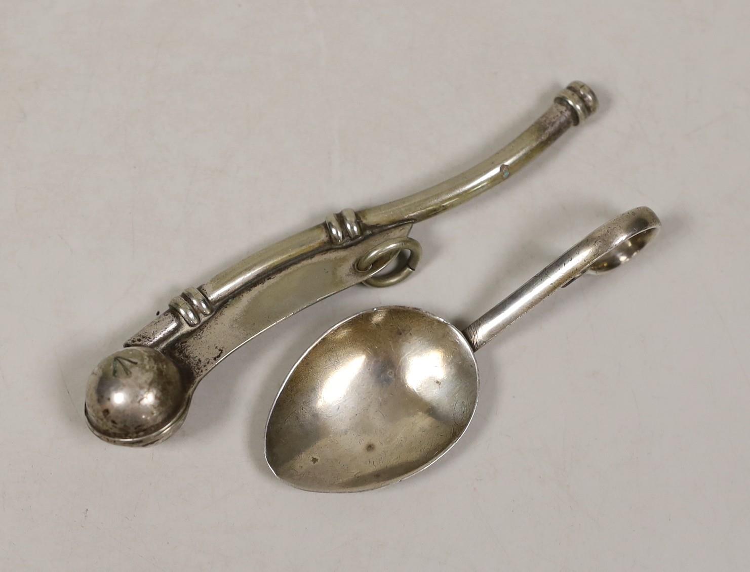 A George V silver caddy spoon and a plated bosun’s whistle.