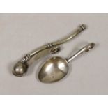 A George V silver caddy spoon and a plated bosun’s whistle.