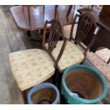 A pair of George III carved mahogany shield back dining chairs