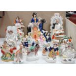 A collection of Victorian Staffordshire pottery flat-back figures and groups, tallest 29cm