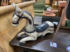 An Indonesian painted carved wood recumbent horse, length 82cm