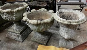 Three circular reconstituted stone garden urns, the largest diameter 48cm, height 55cm