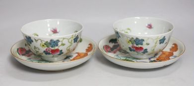 A pair of Chinese famille rose bowls and two similar saucer dishes,