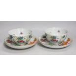 A pair of Chinese famille rose bowls and two similar saucer dishes,