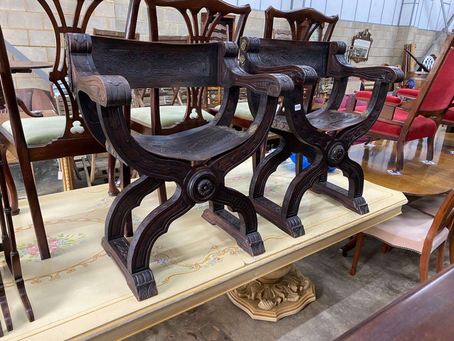 A pair of 19th century Spanish embossed leather and carved walnut framed 'X' framed armchairs, width