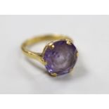An 18ct and synthetic colour change corundum set dress ring, size O, gross weight 6.5 grams.
