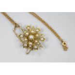 An Edwardian yellow metal and split pearl cluster set starburst pendant brooch, 37mm, on a later 9ct