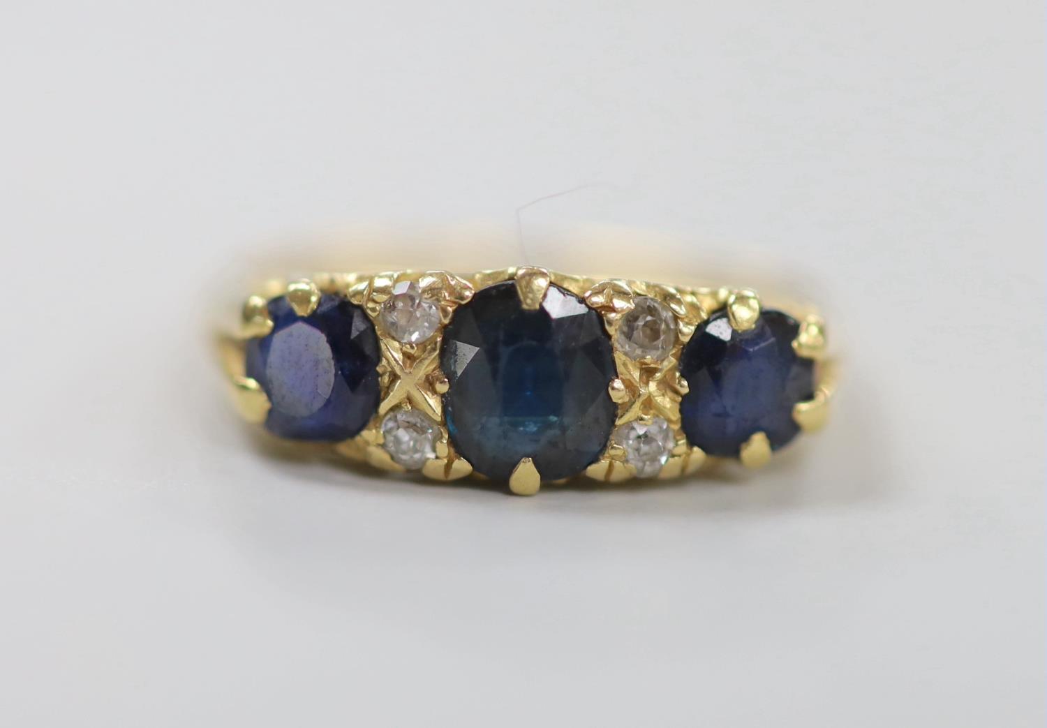 An early to mid 20th century gold, three stone sapphire and four stone diamond chip set half hoop - Image 2 of 4