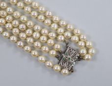 A mid to late 20th century triple strand cultured pearl necklace, with pierced 750 white metal and