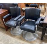 A pair of mid century black leatherette and chrome adjustable barber's chairs, width 62cm