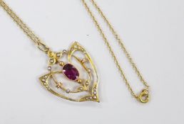 An Edwardian 9ct, garnet and seed pearl cluster set pendant, 33mm, on a later 9ct chain, 39cm, gross
