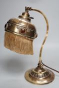 An adjustable Arts and Crafts brass and ‘jewelled’ table lamp, 34cm