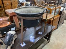 A large 19th century circular copper cauldron on wrought iron stand, diameter 62cm, height 69cm