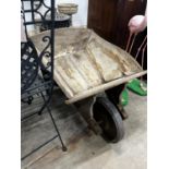 A rustic wooden wheelbarrow, width 60cm, length 110cm, height 53cm