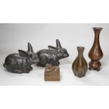 A pair of Chinese bronze models of rabbits, together with two vases and a dragon seal. Tallest 16cm