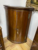 A George III mahogany bow front hanging corner cupboard, width 69cm, depth 49cm, height 105cm