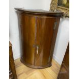 A George III mahogany bow front hanging corner cupboard, width 69cm, depth 49cm, height 105cm