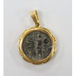 An ancient Roman bronze coin, now in an 18k pendant mount, diameter 21mm, gross weight 11 grams.