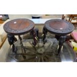 A pair of Indian circular carved hardwood elephant occasional tables, diameter 45cm, height 48cm