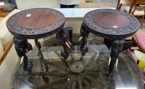 A pair of Indian circular carved hardwood elephant occasional tables, diameter 45cm, height 48cm