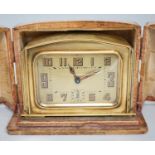 A cased Art Deco brass travelling timepiece
