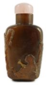 A Chinese brown jasper ‘sage’ snuff bottle, 19th century, carved in high relief with the figure of a