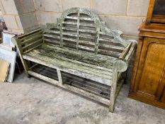 A Lutyens style weathered teak garden bench, length 165cm, depth 64cm, height 101cm